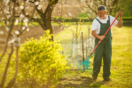 Close-up of hands pruning a shrub, showing tactile gardening tools